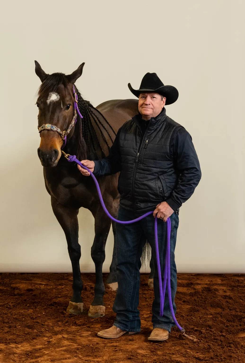 Professional Grooming Community man standing with brown horse