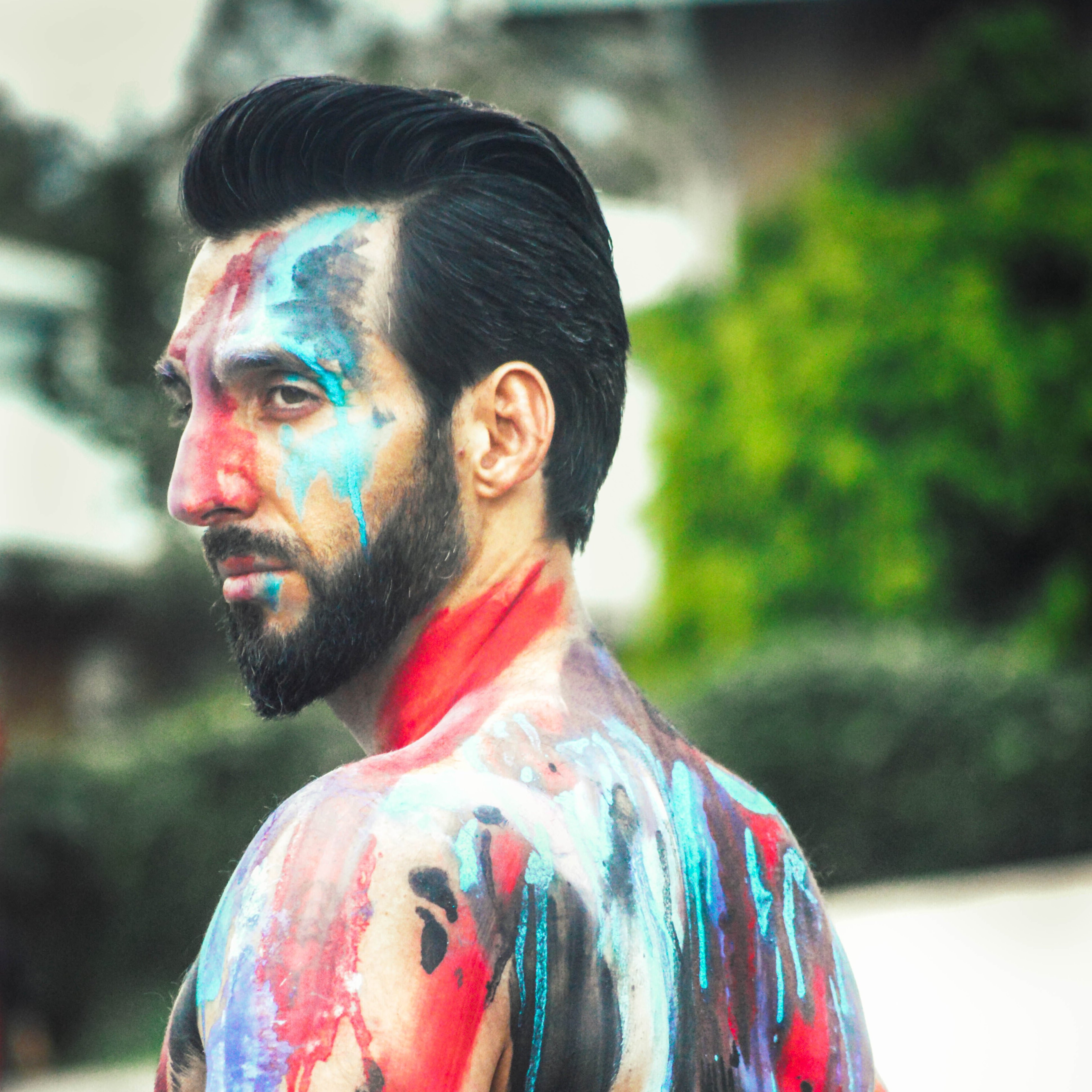 Body painted male model with angle styled beard, and voluminous pompadour haircut by Andis clippers.