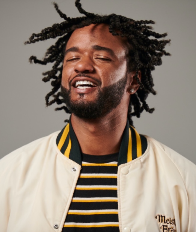 Professional Barber and Stylist Community Man with dreads and white jacket
